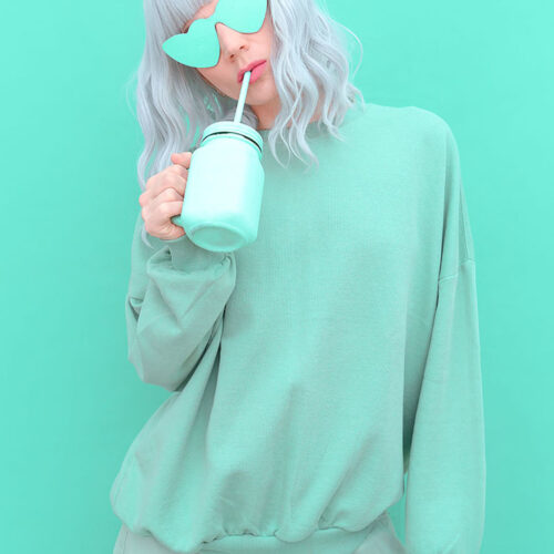 Aesthetic girl in stylish accessories sunglasses and fresh Smoothie. Mint monochrome colours design