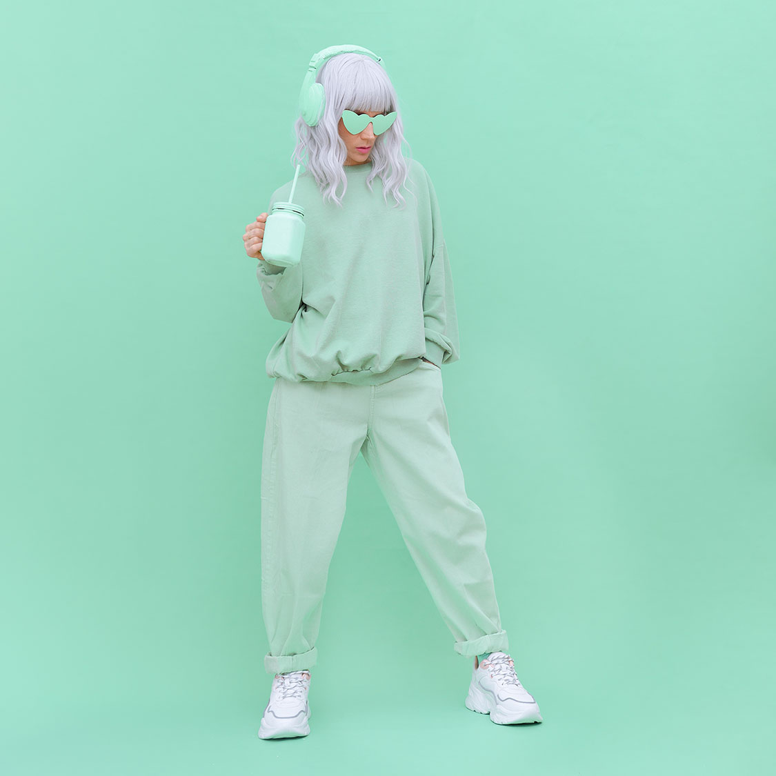 Aesthetic Dj girl drink fresh Smoothie. Minimal monochrome fashion design. Aqua menthe color trend