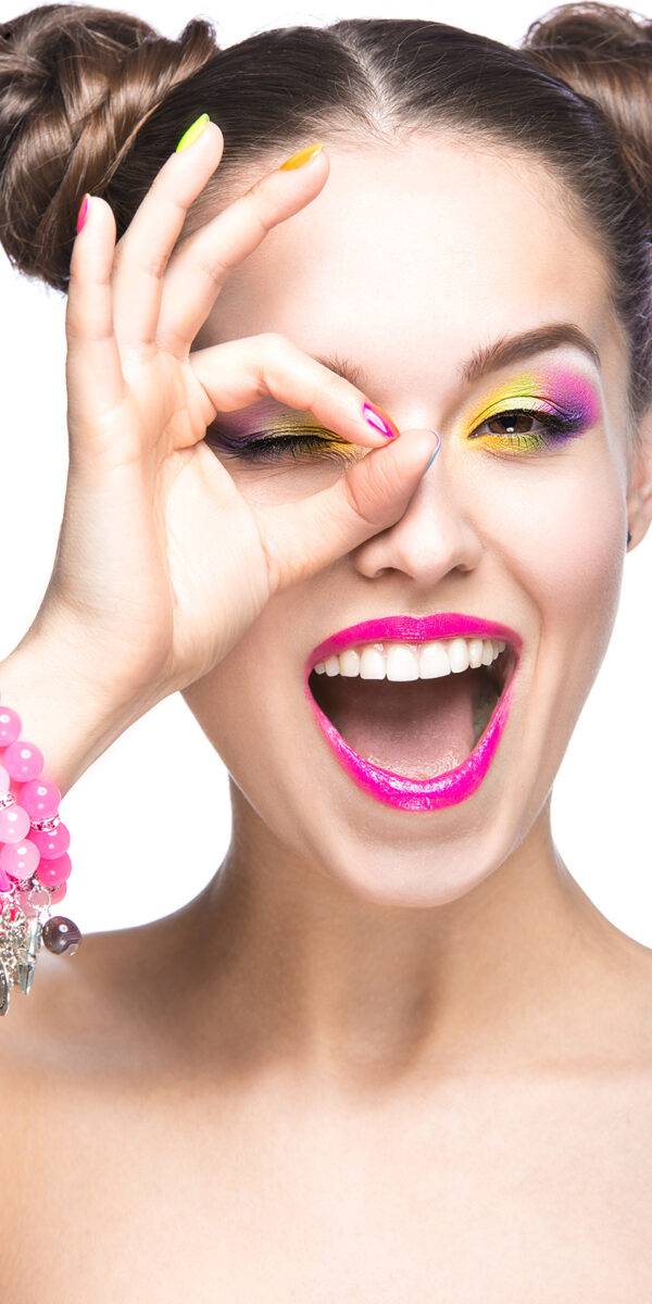Beautiful girl in pink sunglasses with bright makeup and colorful nails. Beauty face. Beautiful girl in pink sunglasses with bright makeup and colorful nails. Beauty face. Picture taken in the studio on a white background.