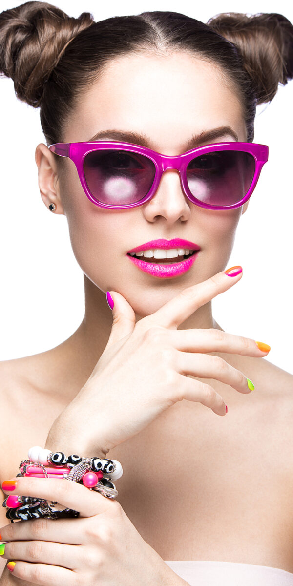 Beautiful girl in pink sunglasses with bright makeup and colorful nails. Beauty face. Beautiful girl in pink sunglasses with bright makeup and colorful nails. Beauty face. Picture taken in the studio on a white background.