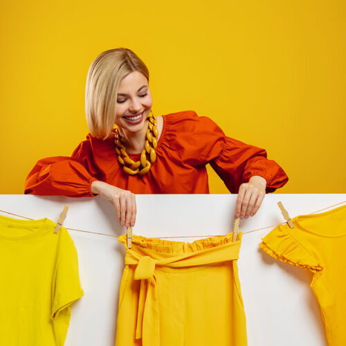 beautiful-young-woman-hanging-her-colorful-clothes-2023-11-27-05-26-32-utc