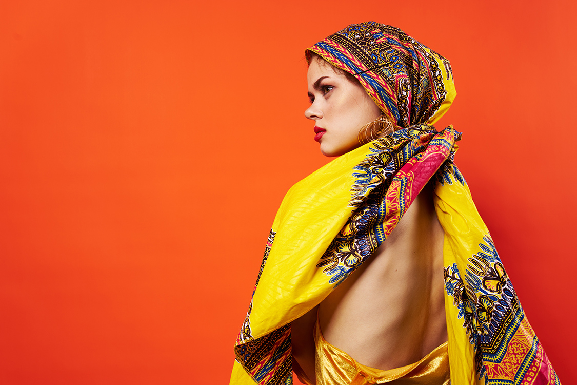 cheerful woman ethnicity multicolored headscarf makeup glamor red background