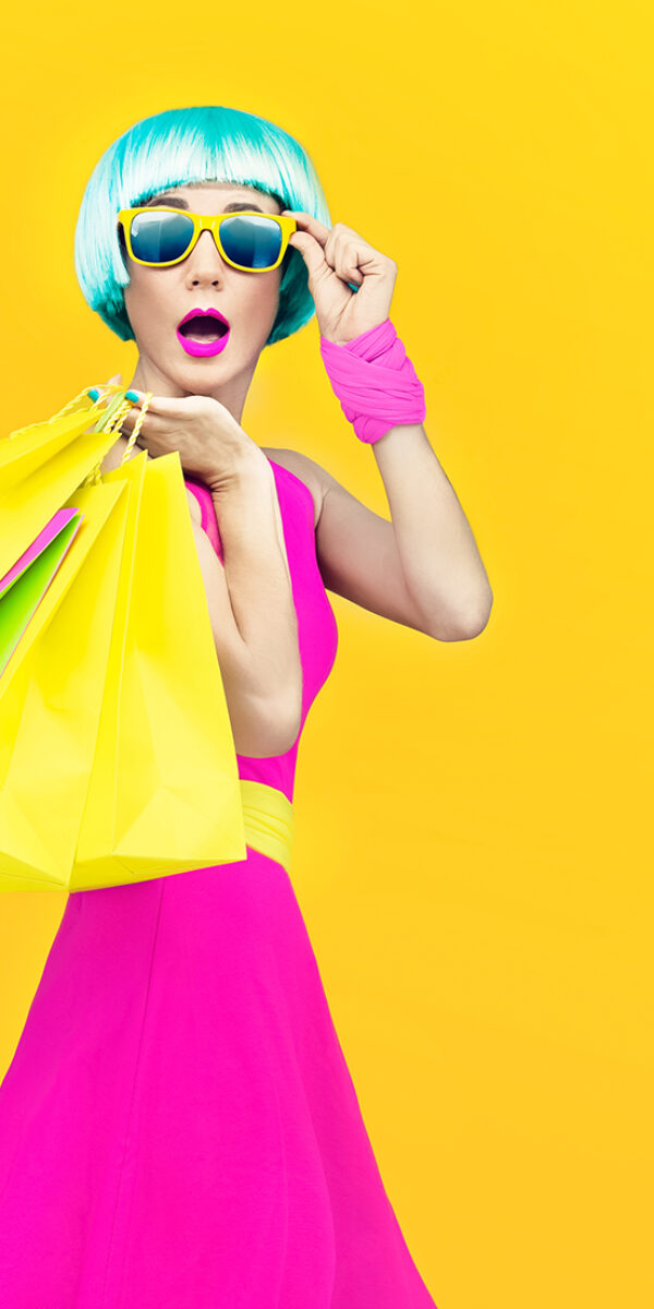 crazy fashion shopping girl on yellow background