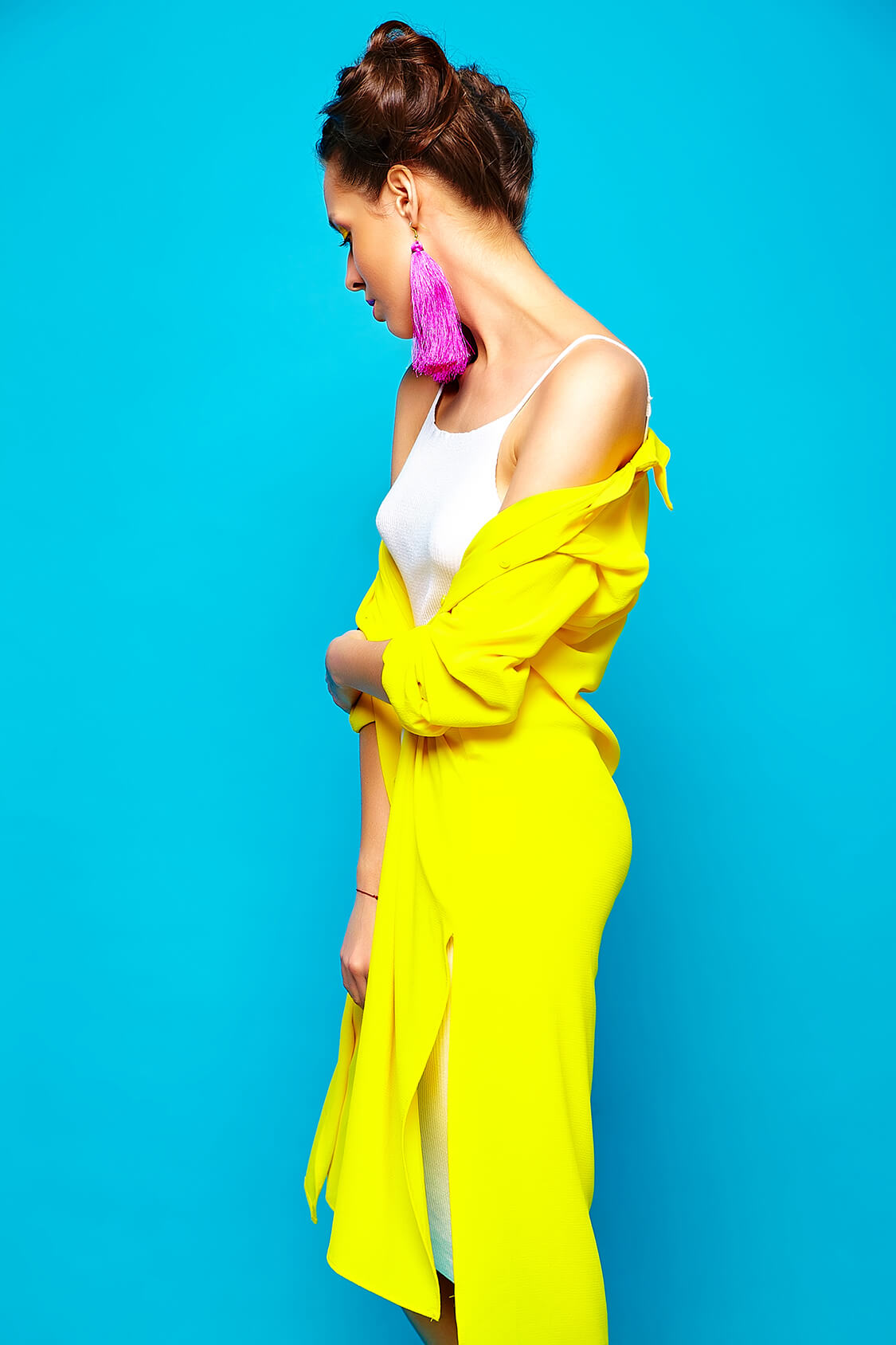 Portrait of young stylish woman with creative hairstyle posing in studio