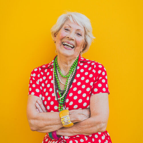 Funny grandmother dancing on colored background Funny grandmother dancing on colored background