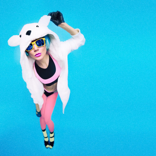 Funny party girl in hoodie bear on a blue background. Bright winter time