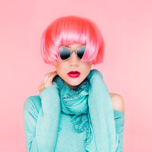 Glamorous fashion lady in pink wig Glamorous fashion lady in pink wig on pink background