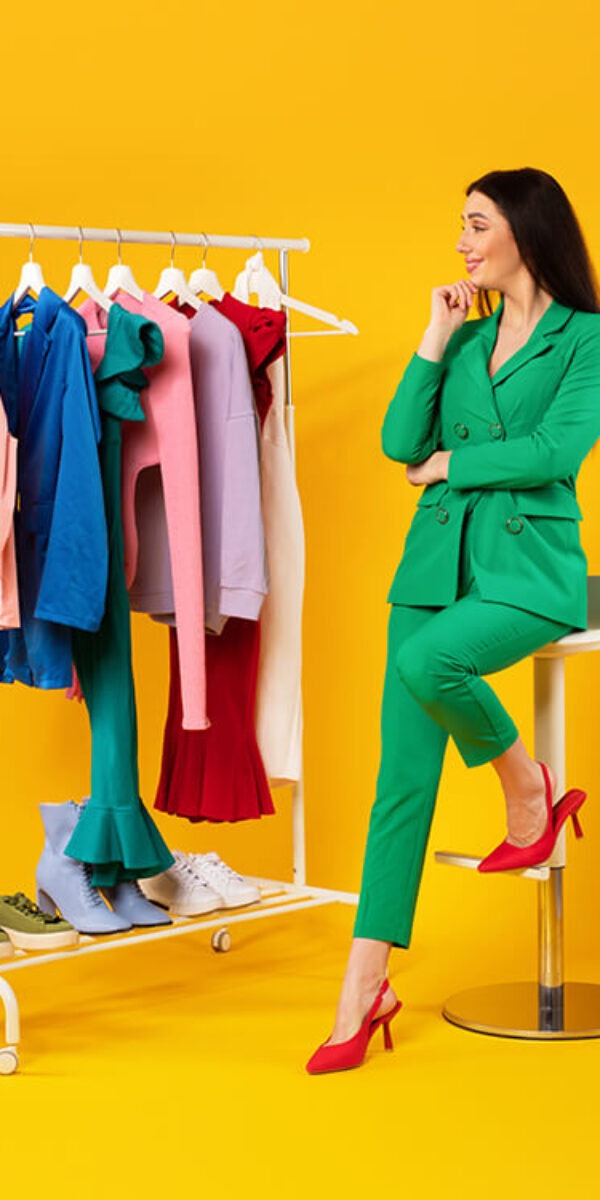 pensive-young-stylish-lady-looking-at-garment-rack-2023-11-27-05-11-36-utc