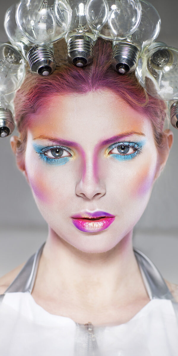 Portrait of a futuristic young beautiful woman with creative make up
