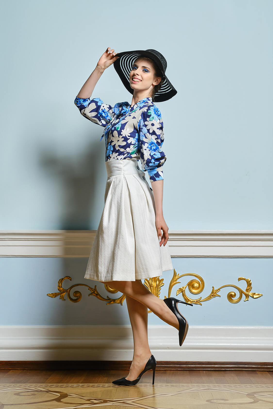 Portrait of beautiful girl in broad brim hat, blouse and skirt w