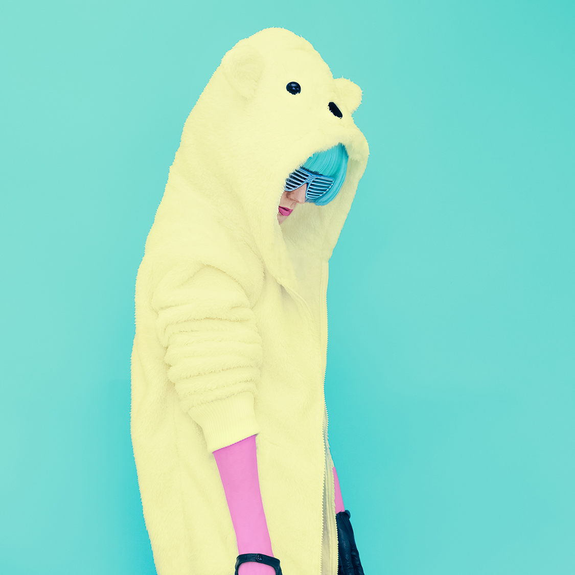 Teddy bear crazy girl in a bright hoodie on a blue background co