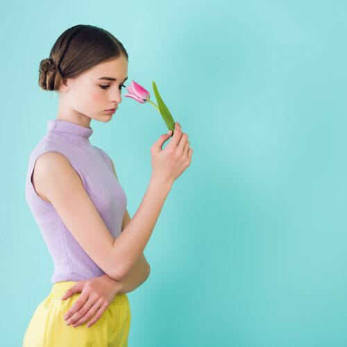 tender teen girl posing with tulip flower, isolated on turquoise tender teen girl posing with tulip flower, isolated on turquoise