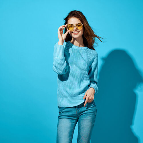 woman in a blue sweater blue background Lifestyle. High quality photo