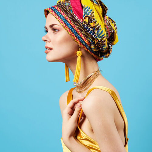 woman in multicolored turban luxury ethnicity blue background woman in multicolored turban luxury ethnicity blue background. High quality photo