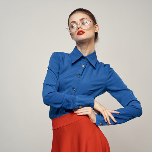 woman model in blue shirt and red skirt glasses beautiful face makeup studio woman model in blue shirt and red skirt glasses beautiful face makeup studio. High quality photo