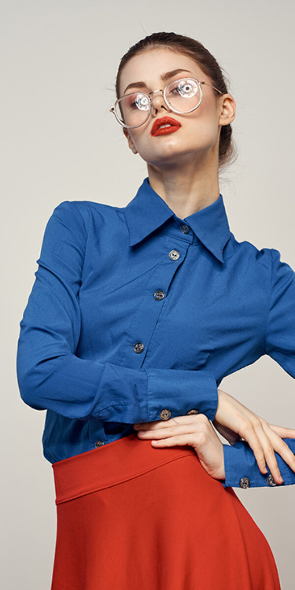 woman model in blue shirt and red skirt glasses beautiful face makeup studio. High quality photo