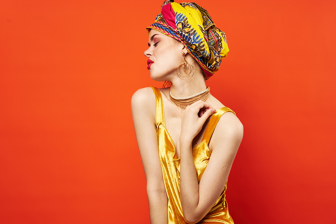 woman with multicolored turban decoration red lips charm emotions red background