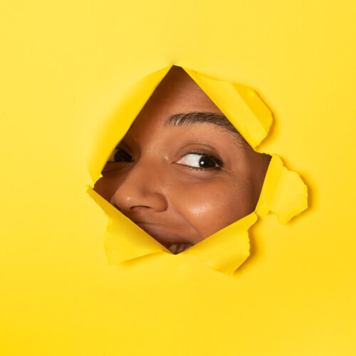 young-african-american-lady-peeking-out-of-a-hole-2023-11-27-05-33-47-utc